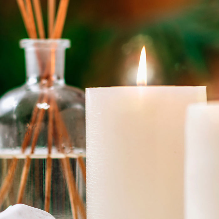 reed diffuser with candles and stones