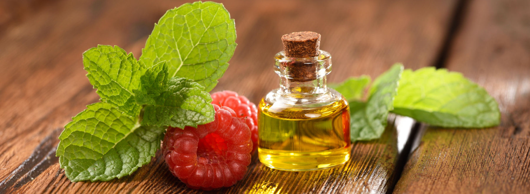 oil bottle with raspberry and leaves