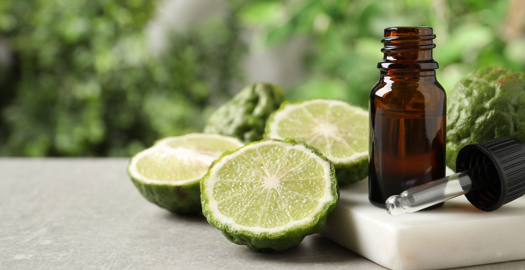 bergamot essential oil bottle with sliced bergamot