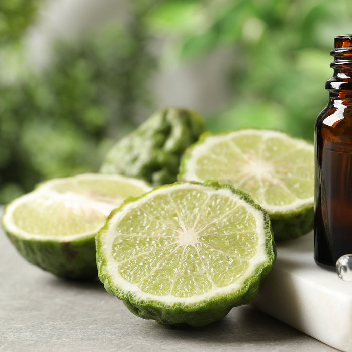 bergamot essential oil bottle with sliced bergamot