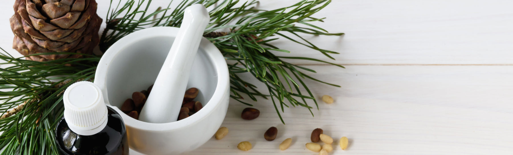 essential oil bottle with cedarwood branches