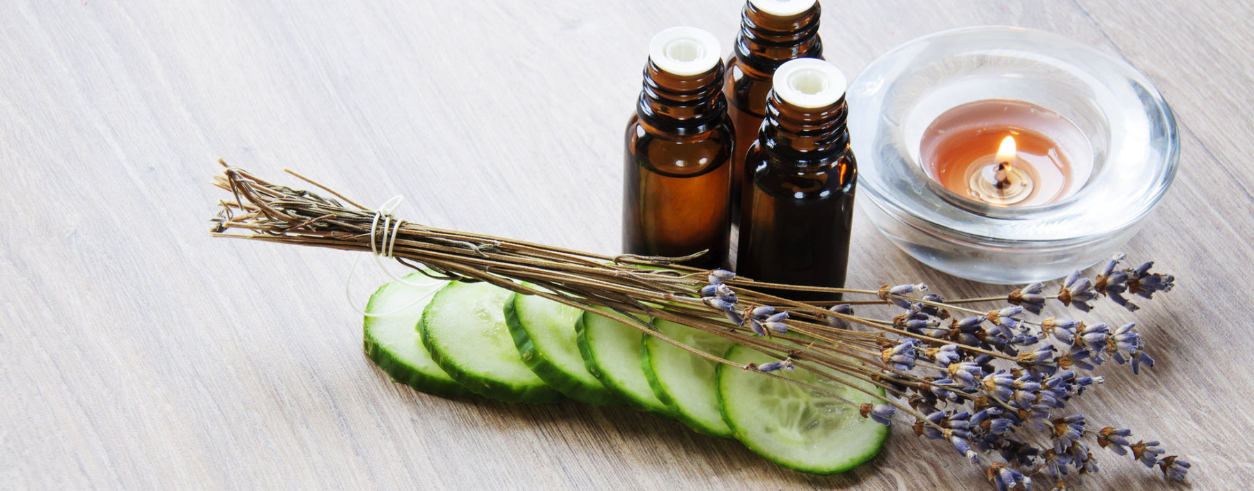 cucumber slices with amber bottles and candle