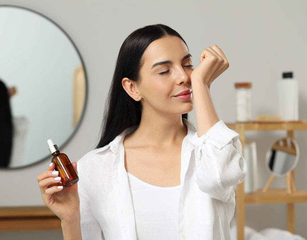 Woman applying carrier oil 